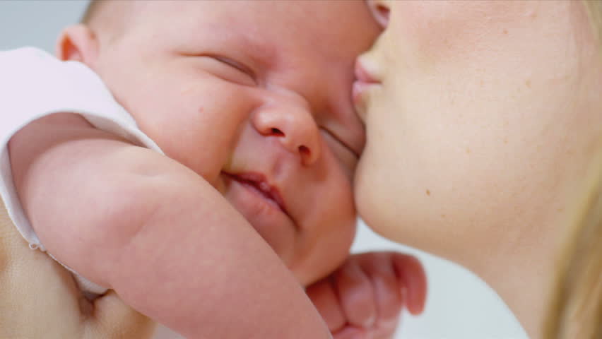 Loving Mother Kissing Baby Daughter