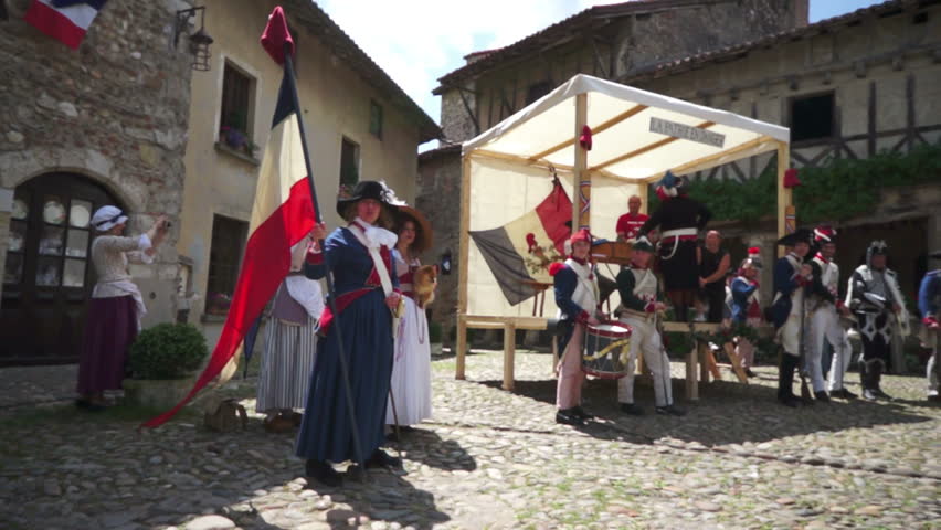 PEROUGES,FRANCE-JULY 14, 2012:Scene of a French Revolution historic commemoration,celebrated every year by many folks wearing the common clothes of that time;here a patriot goes towards the recruiters