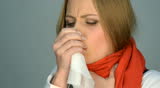 sick and sad woman in red scarf coughing and sneezing. video in studio