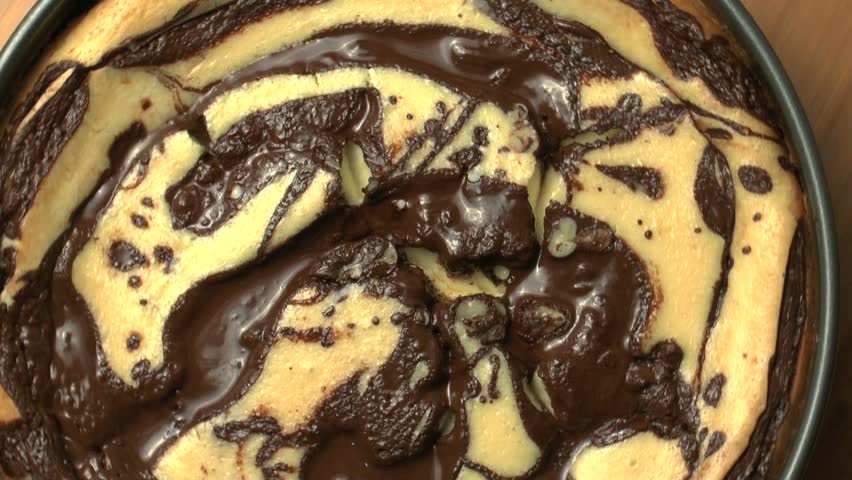 Freshly baked cheesecake, swirled with rich, dark chocolate, rotates, close up. 1080p