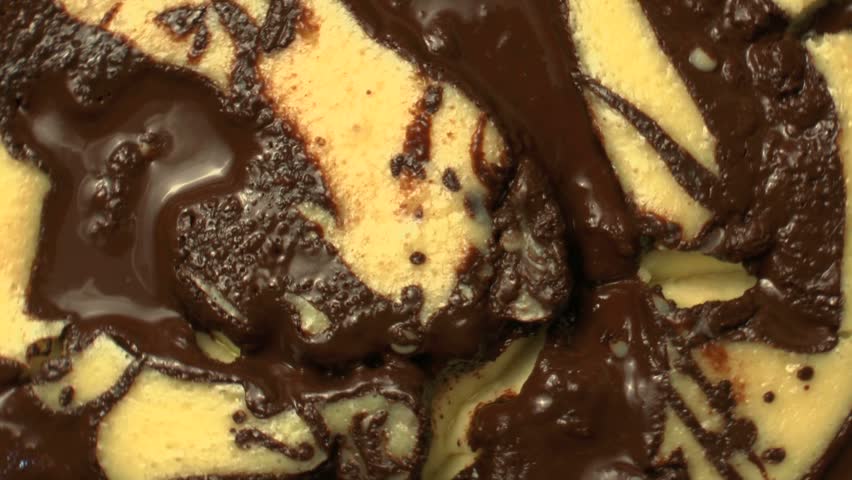 Close-up of freshly baked cheesecake, swirled with melted chocolate, rotates, zoom out. 1080p