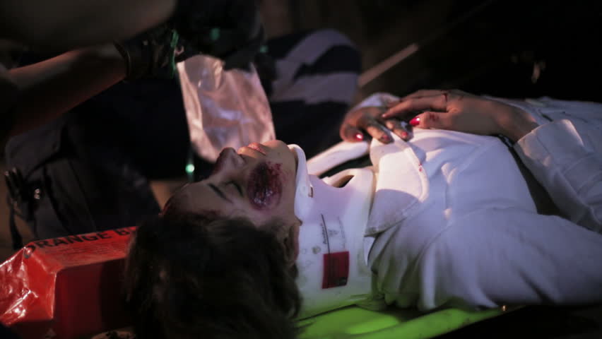 Unconscious and injured woman with neck brace and in stretcher 