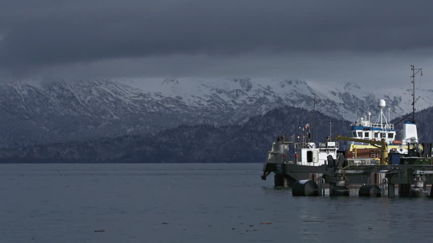 HOMER, AK - CIRCA 2012: A CISPRI (Cook Inlet Spill Prevention and Response, Inc.) Responder barge being towed away from Homer's ferry dock.