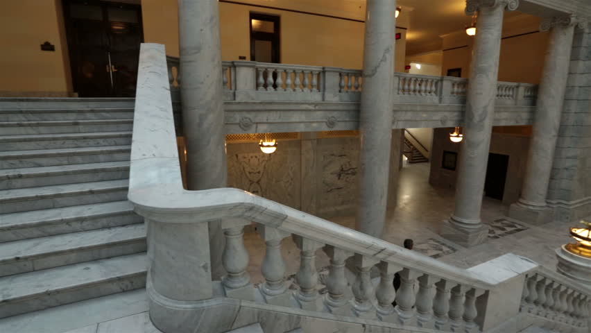 SALT LAKE CITY, UTAH NOV 2012: Utah State Capital pan across stairs man walks away. Utah State capital building high on hill overlooking city of Salt Lake City. Elegant architectural interior design.