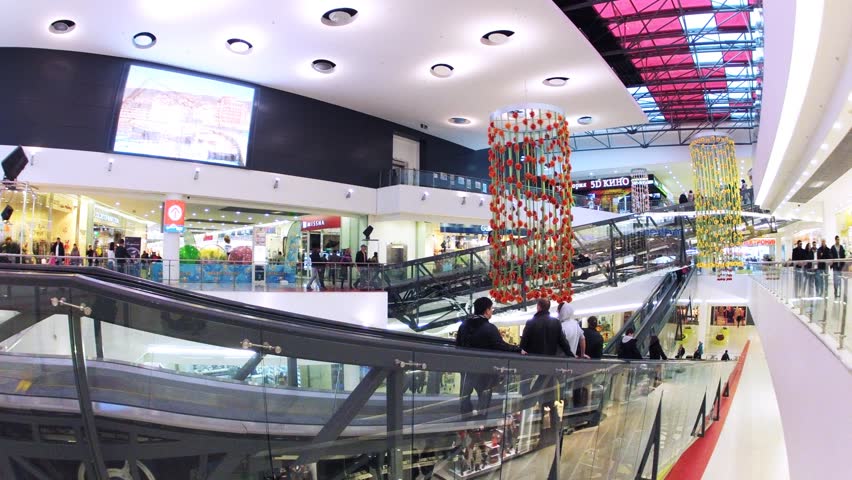 MOSCOW - OCT 28: (Time lapse) People in motion on escalators in Gagarinsky mall near big screen, on Oct 28, 2012 in Moscow, Russia. Shopping and entertainment center Gagarinsky has 60 fashion shops.