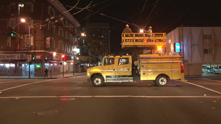 SAN FRANCISCO, CA - CIRCA 2012: San Francisco street view at night, or early morning. Construction crew fixes a wire. 