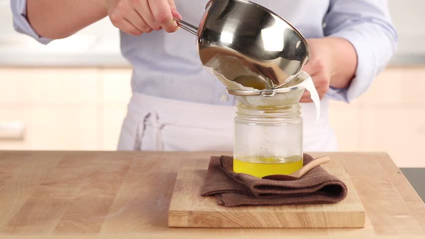 Clarified butter being sieved