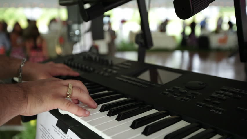A keyboardist plays at a wedding