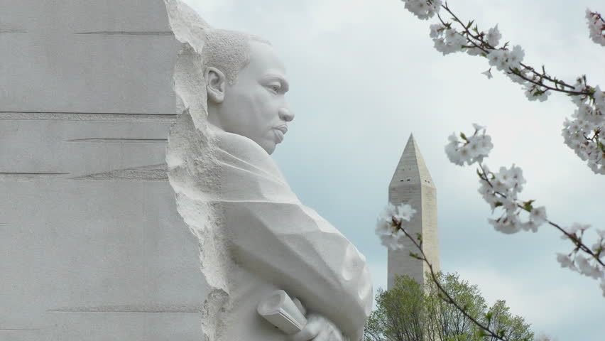 WASHINGTON, DC.  MARCH 2012 - Martin Luther King Memorial with Washington Monument in distance provides one of many photo-op angles for visitors, especially when cherry blossoms are about to bloom.
