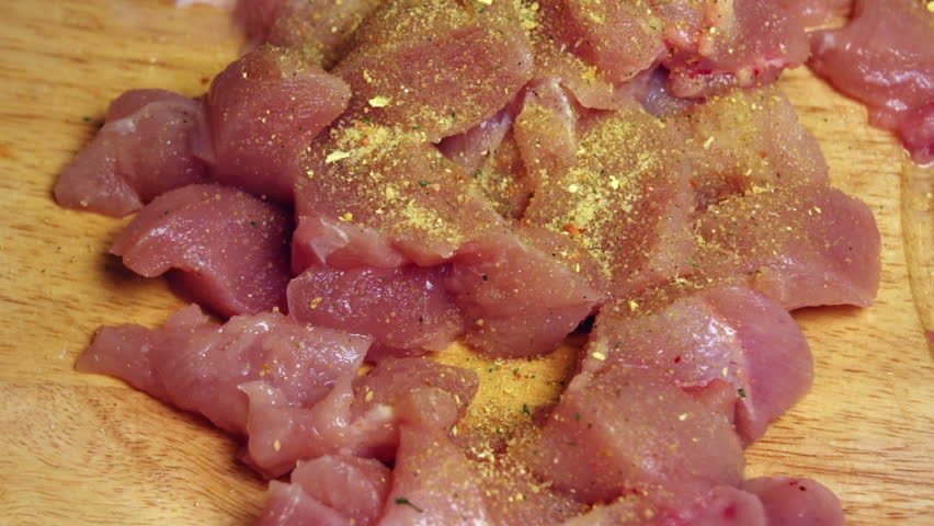 Super 35mm camera - seasoning chicken meat and mixing it by hand
