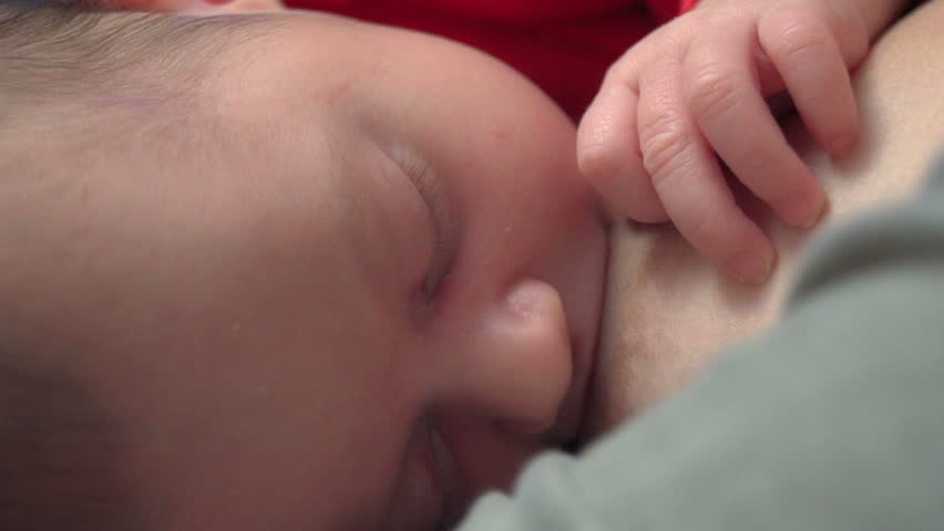 Beautiful one month old baby girl feeding - breastfeeding 