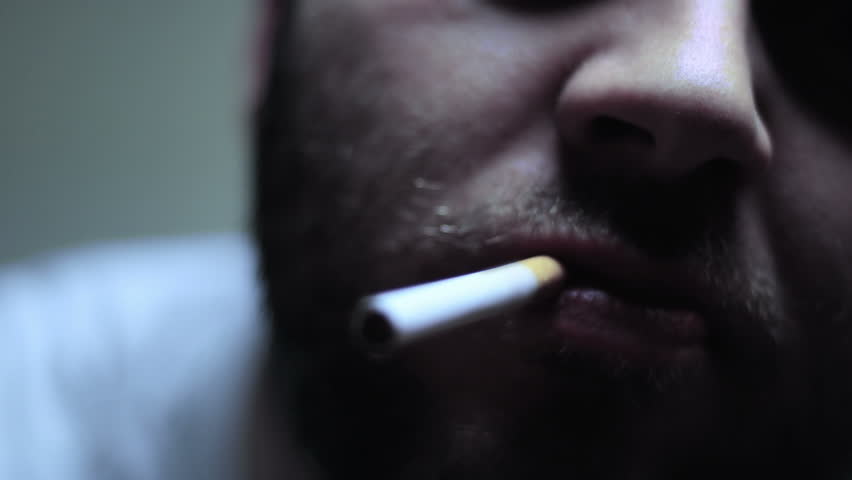 SUPER 35MM CAMERA - Bearded man lighting and smoking a cigarette 