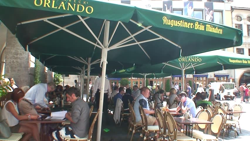MUNICH, GERMANY - CIRCA 2011: Germans and tourists eating and drinking in the vacinity of the Hofbrauhaus in Munich.
