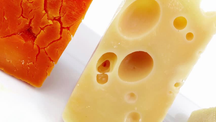 aged parmesan roquefort and gruyere chops delicatessen cheeses on white plate isolated over white background