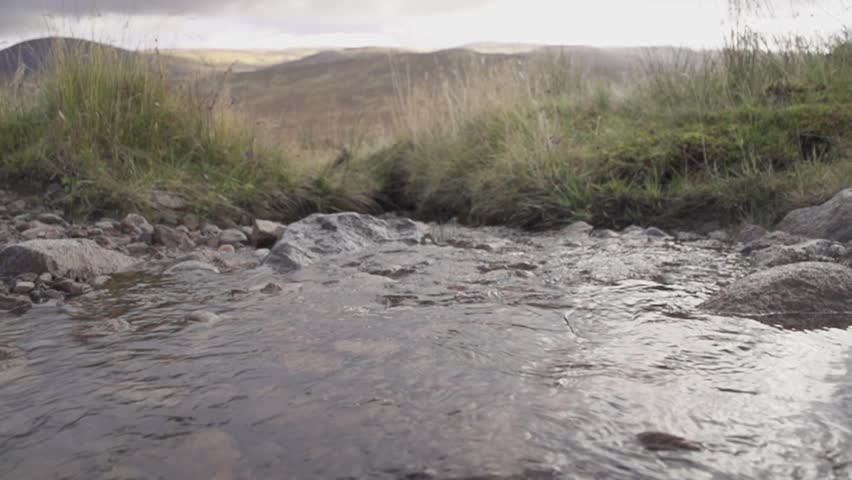 Hiking boot in water in Scotland - slow motion (1080p400 conformed to 1080p25)