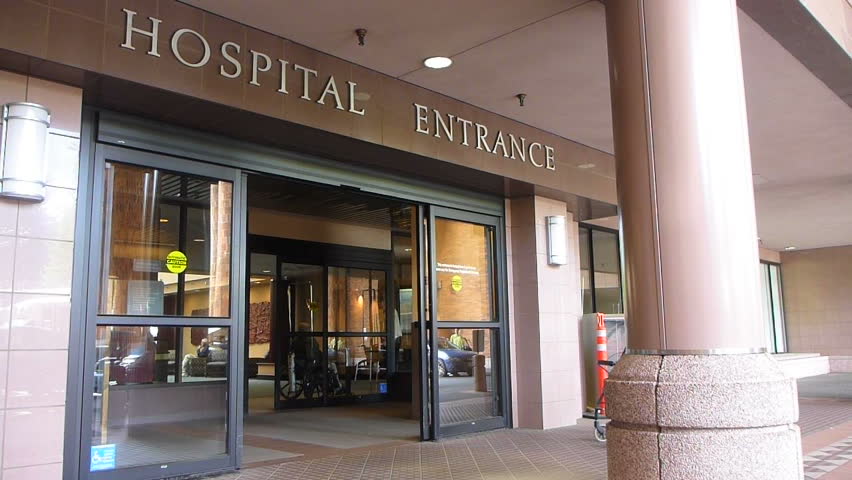 PORTLAND, OREGON - CIRCA 2012: Hospital entrance with patients entering and exiting through front door.