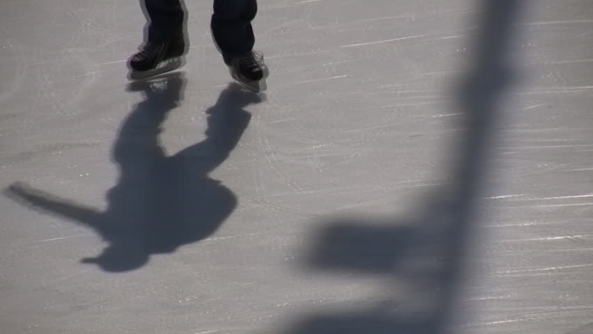 Closeup shot of an ice skater's feet on an ice rink (High Definition)
