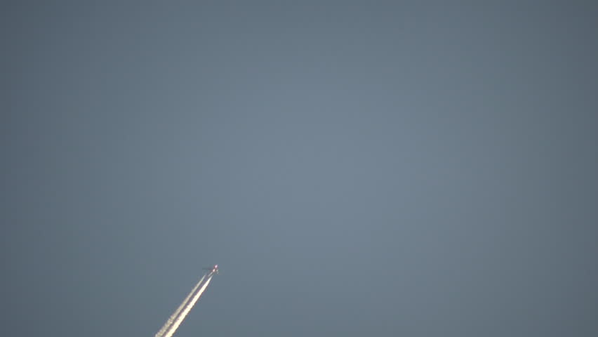 Condensation vapour trails are left behind from a passing airplane.  Also known as contrails, cirrus clouds, or wingtip vortices (High Definition)