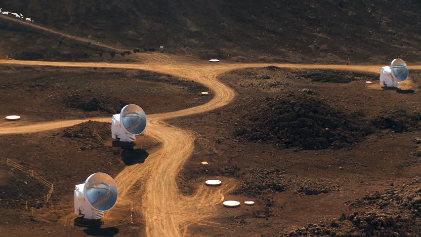 Collection of radio telescopes (VLA) & access road in barren location