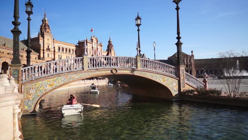 SEVILLE, SPAIN - JANUARY 6: Tourists enjoy a trip on boat on Plaza de Espana Seville on Jan 6, 2013 It was built in 1928 for the Ibero-American Exposition of 1929 designed by architect Anibal Gonzalez