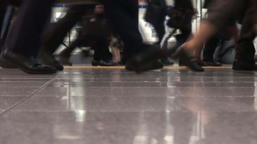 TOKYO, JAPAN - 6 NOVEMBER 2012: People make their way to work during early morning rush hour at the Shinagawa train station in Tokyo, Japan