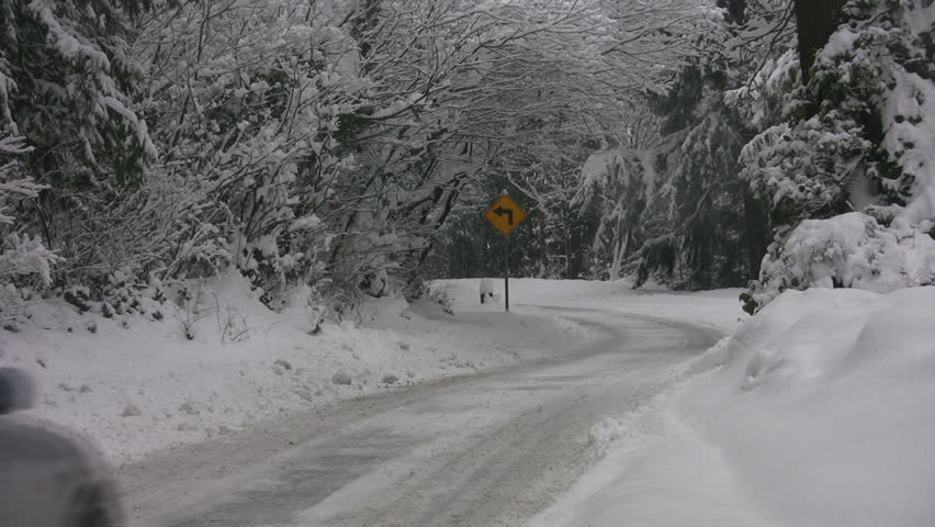 VANCOUVER, CANADA - DECEMBER 24: Car beats snowplow, Vancouver, BC, Canada, December 24, 2008. Holiday storms, broke snowfall records in many parts of western Canada. 