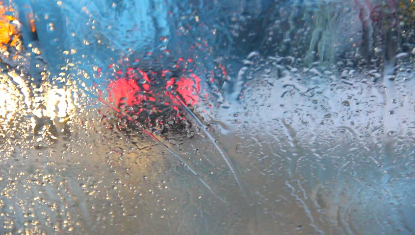 Traffic through rainy window.