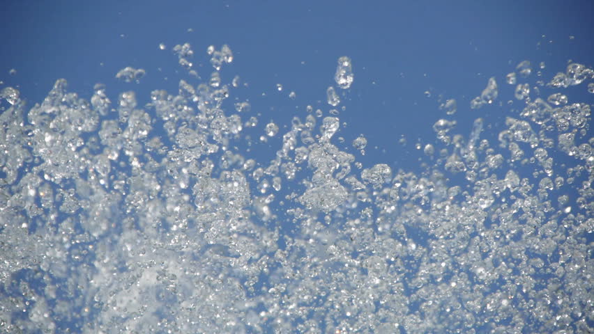 Fountain splash on clear blue sky 