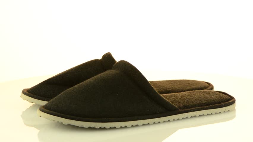 A pair of grey slippers on a white background.