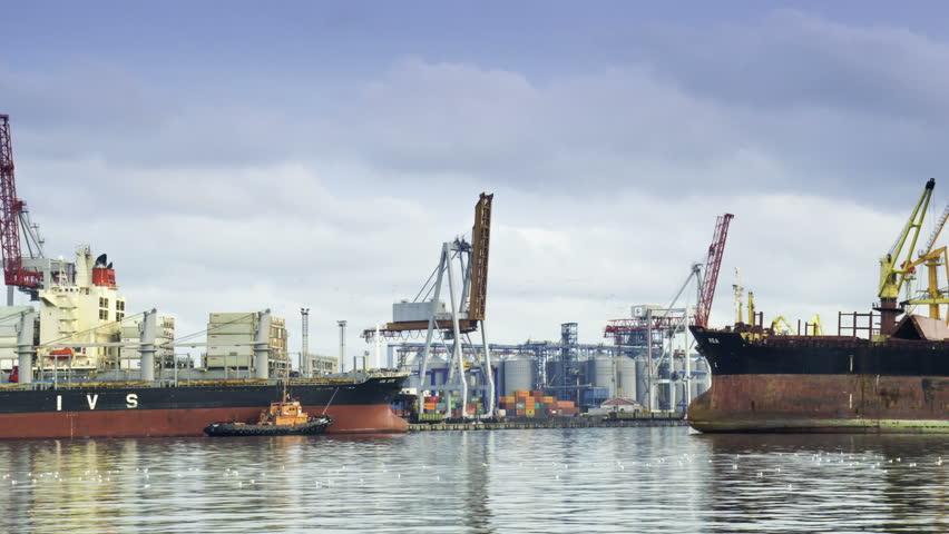ODESSA - JANUARY 10 (TIMELAPSE): Cargo ship enters in port with tugs assistance on January 10, 2013 in Odessa, Ukraine. Odessa port is one of the largest trading ports located on the Black Sea coast.