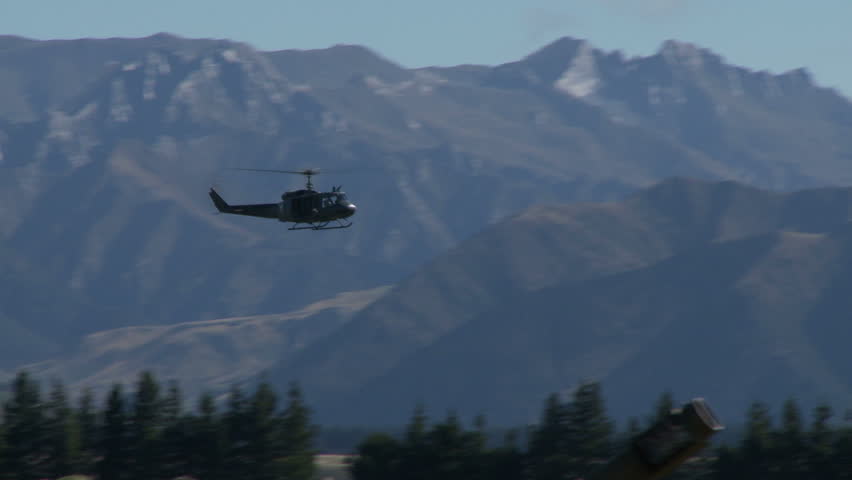 Pan left to right of an Iroquois helicopter in flight