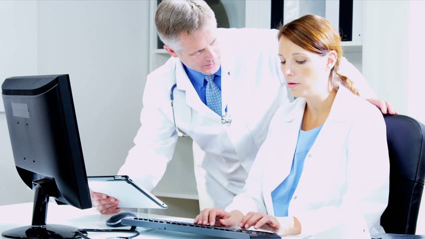 Female male Caucasian doctors checking medical information using technology shot on RED EPIC