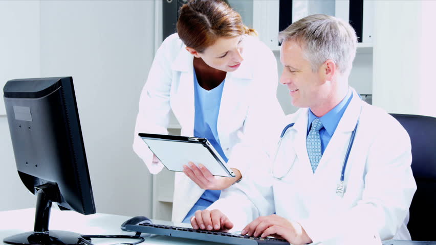 Caucasian Male female medical team members using tablet computer hospital rooms shot on RED EPIC