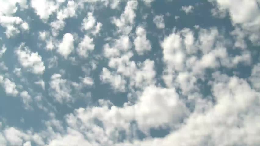 High clouds time-lapse running over camera with blue sky and sun out of frame but angling in for strong lighting.