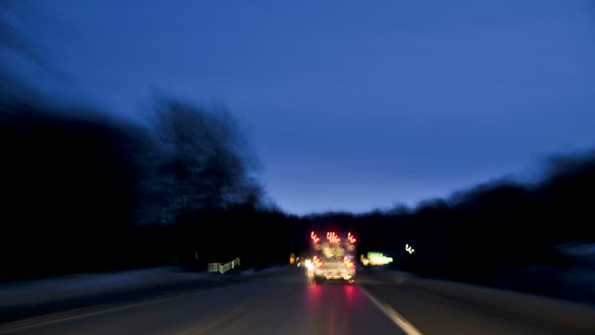 time-lapsed drive behind an on duty ambulance as it makes it's way along a rural road to the hospital. Lights are on, but not flashing. 