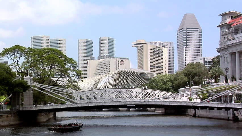 SINGAPORE - CIRCA FEBRUARY 2008: Singapore River with Tourist Boats and the Cavenagh Bridge and the Skyline of Marina Bay
