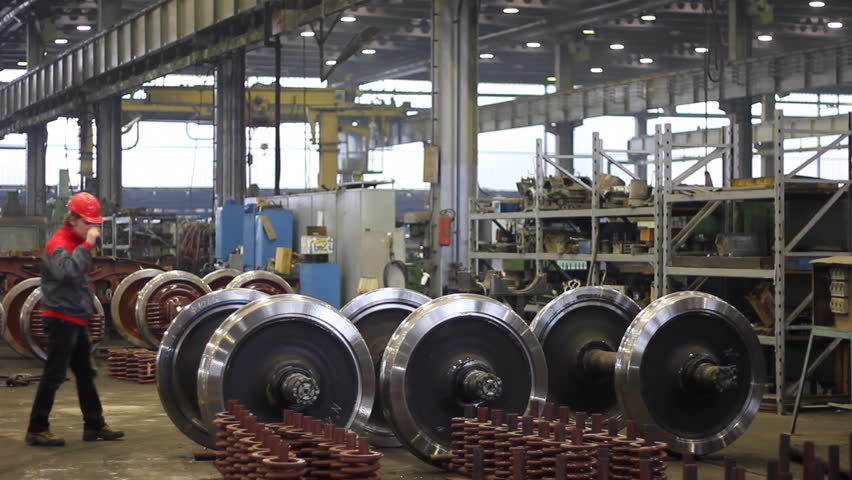 Worker controls wheels in factory overhaul of rail vehicles