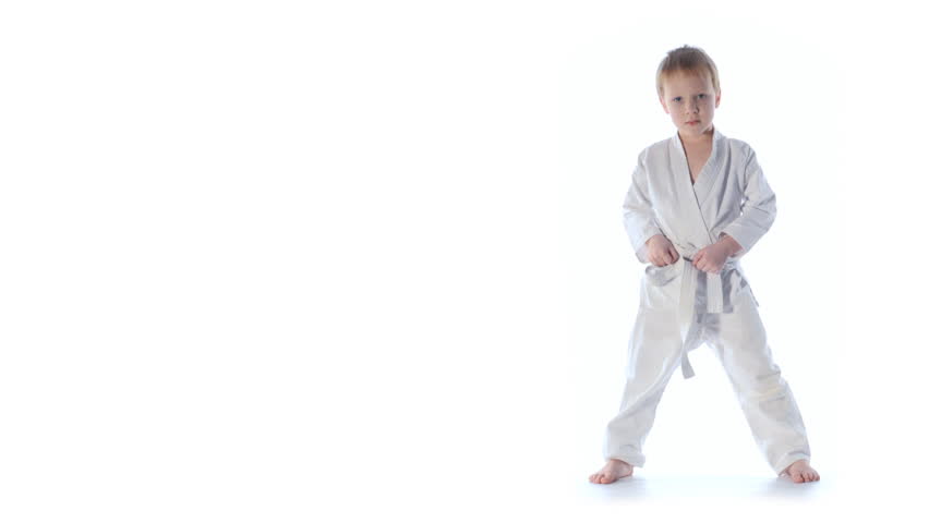 Karate boy exercising isolated against white background