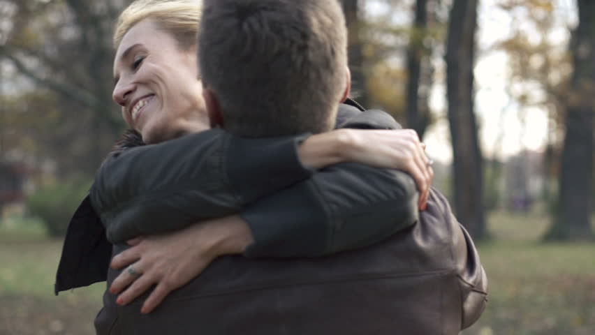 Happy couple hugging in the park, slow motion, shot at 240fps
