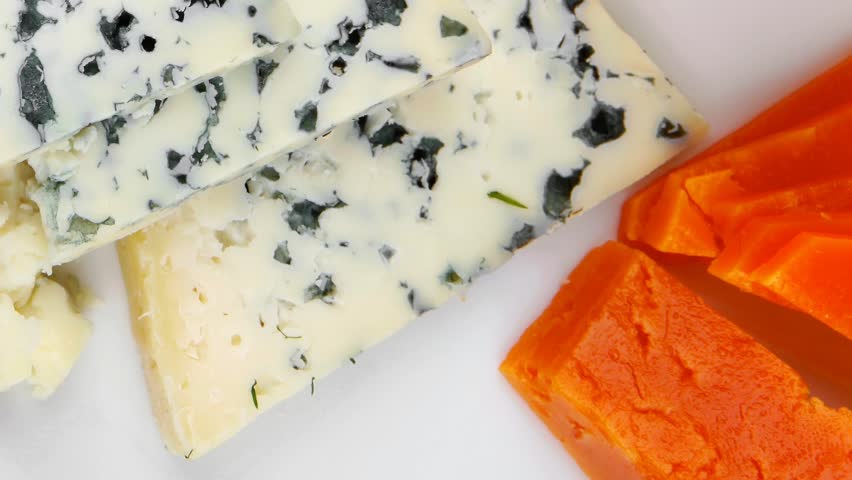 french delicatessen aged cheeses chops served on white plate with slices hidef intro slow motion