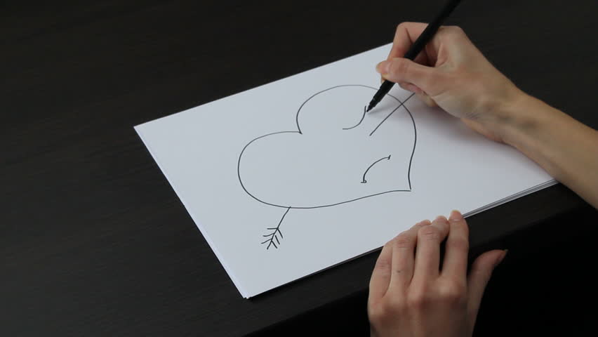 Female hand drawing heart