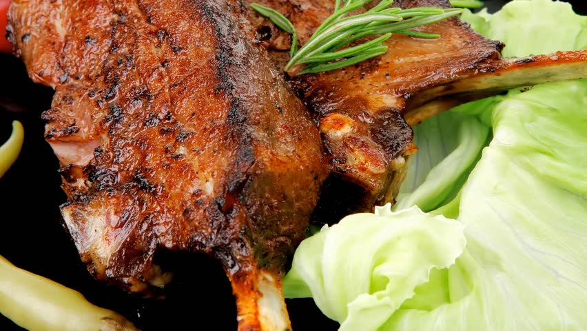 served entree: ribs on plate with hot peppers and capers