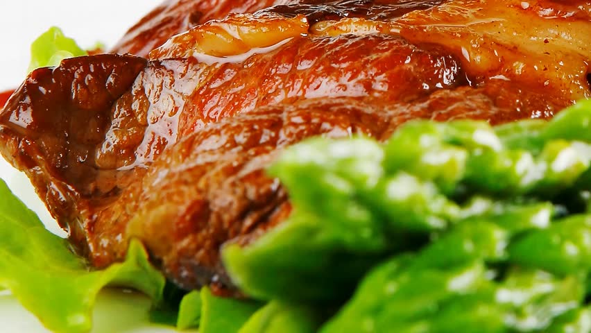 served roasted beef meat with asparagus on white dish