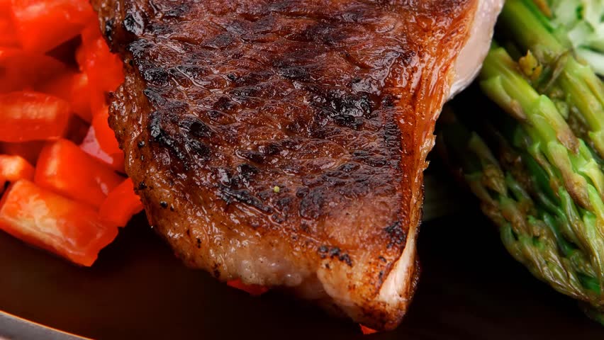 meat table : grilled beef fillet with asparagus and tomatoes served on dish hidef slow motion intro