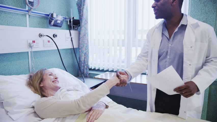 Two patients are visited by their medical teams who chat to them and attend to their needs. 