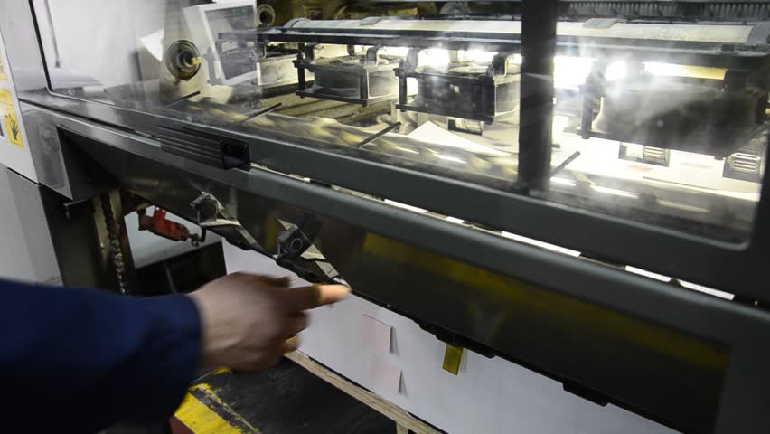 taking out the printed sheet on offset machine for final color management control measurement
