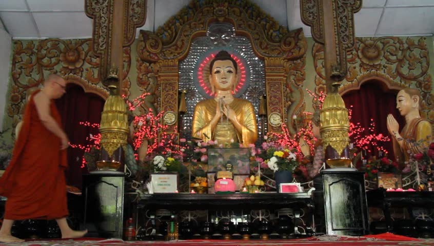 GEORGETOWN, MALAYSIA - CIRCA JANUARY 2013 Monk near altar in buddhist burmese temple