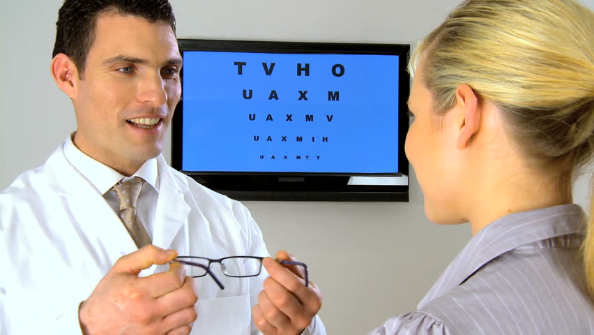 Ophthalmic optician practicing eye care with patient