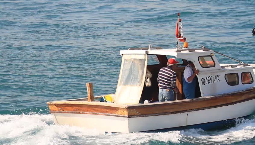 ISTANBUL - JUNE 2: Fisher boat sails through the Bosporus Sea on June 2, 2012 in Istanbul. Offshore fishing contributes a significant income in here. 
