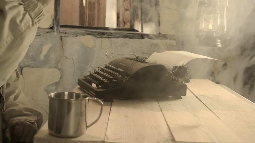 Placing his combat helmet on a makeshift table in a bombed out building a man contemplates the dog tags of a fallen soldier and begins typing a condolence letter.